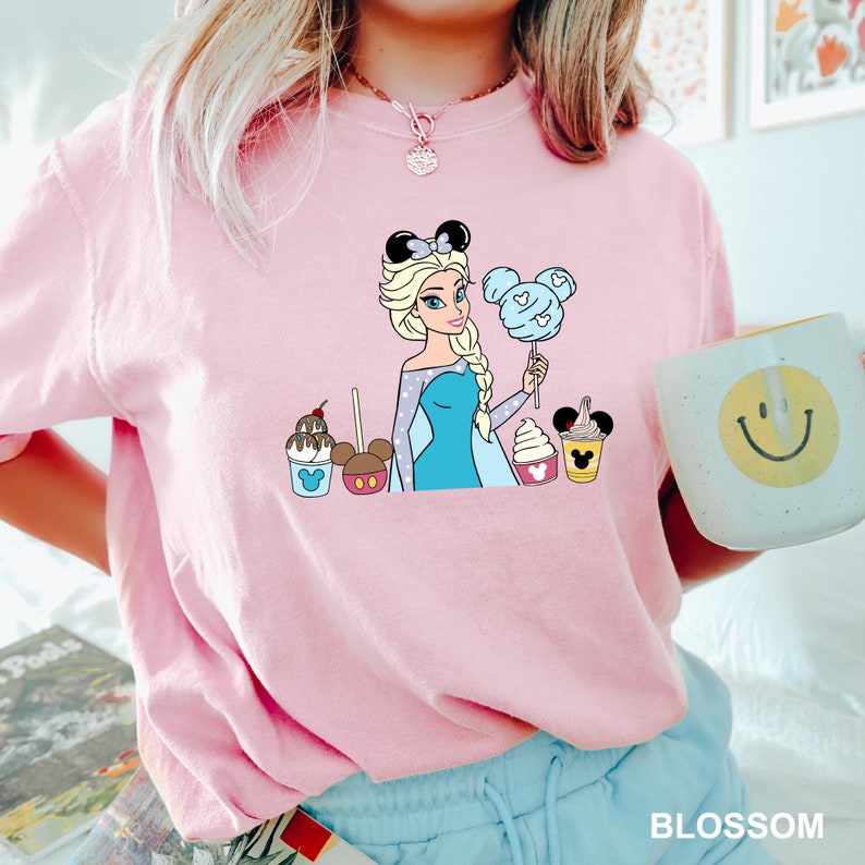 a woman in a pink shirt holding a cup of coffee