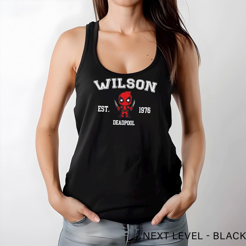 A woman wearing a black tank top with a graphic of a character from the Marvel Cinematic Universe.