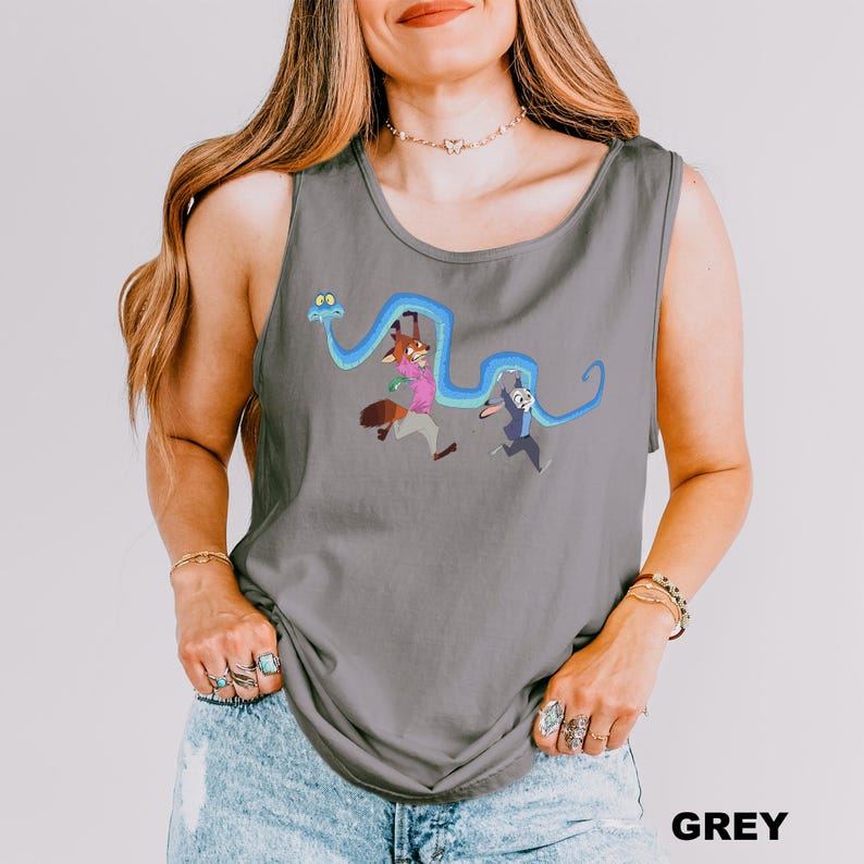A woman wearing a gray tank top with a graphic design of cartoon characters and a snake.