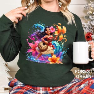 a woman is holding a coffee mug and wearing a sweatshirt