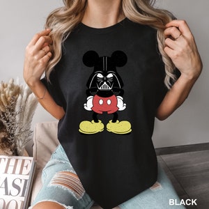 a woman wearing a mickey mouse t - shirt