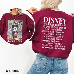 a woman wearing a disney cast tour sweatshirt