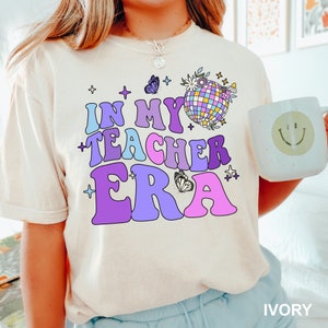 a girl wearing a t - shirt that says in my teacher era