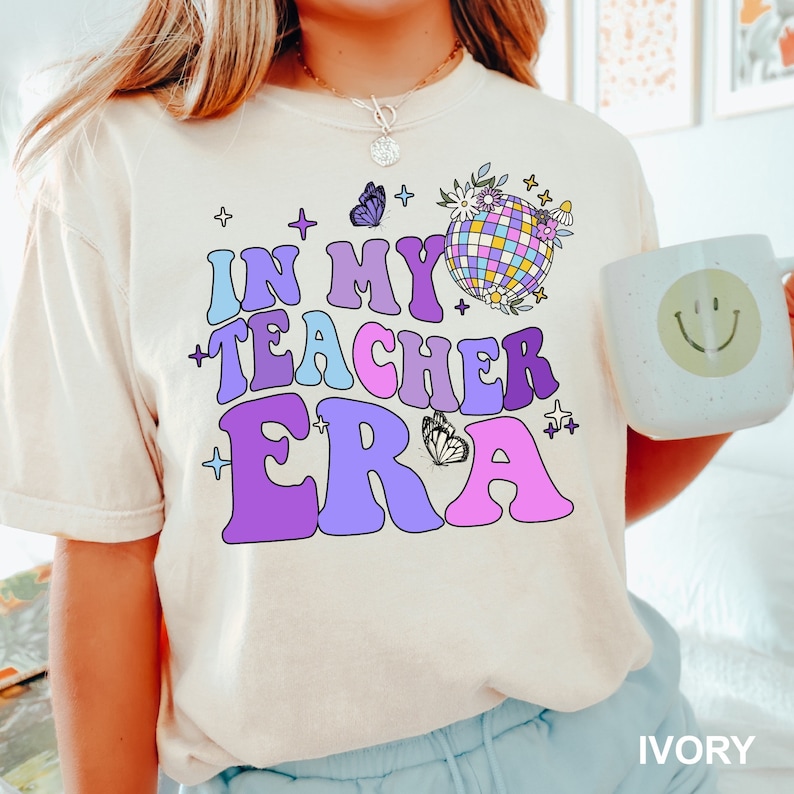 a girl wearing a t - shirt that says in my teacher era