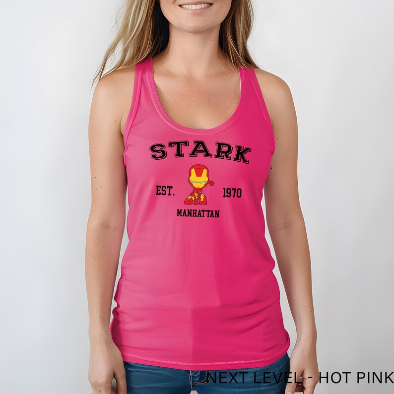 A woman wearing a pink tank top with the text "STARK EST. 1970 MANHATTAN" printed on it, along with a small illustration of a character from the Marvel Cinematic Universe.