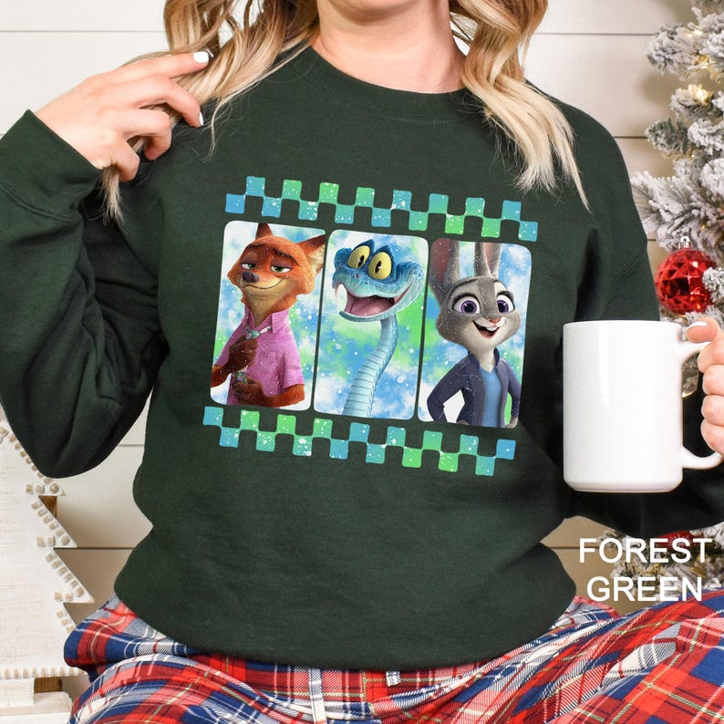 A woman wearing a green sweatshirt with a graphic design featuring cartoon animal characters.