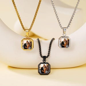 May include: Three personalized photo necklaces. One is gold-toned, one is silver-toned, and one is black. Each necklace features a square pendant with a photo of a couple. The chains are different styles.