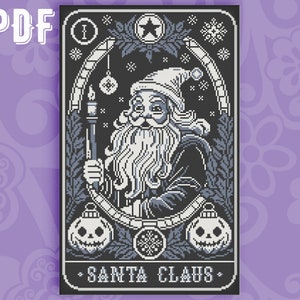 May include: A black and white cross-stitch pattern of Santa Claus holding a candle. The pattern is framed with a decorative border and includes the text "SANTA CLAUS".