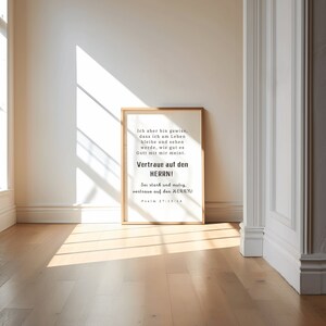 May include: A framed print with a white background and black text. The text reads: "Ich aber bin gewiss, dass ich am Leben bleibe und sehen werde, wie gut es Gott mit mir meint. Vertraue auf den HERRN! Sei stark und mutig, vertraue auf den HERRN! Psalm 27:13-14"