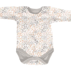 May include: A long-sleeve baby bodysuit featuring a repeating floral pattern in soft peach and muted gray tones against a white background. The garment includes a solid gray crew neckline, gray sleeve cuffs, and gray leg openings with snap closures.