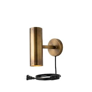 May include: A wall-mounted lamp with a cylindrical brass-toned metal shade featuring a row of small perforations at the top and bottom. The fixture includes a circular wall plate, a horizontal arm, and a black power cord with an integrated switch.