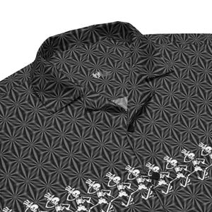May include: A black button-up shirt with a geometric pattern and a band of dancing skeletons at the bottom. The skeletons are wearing top hats and are in a line.
