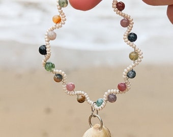 Woven bracelet with seashell charm