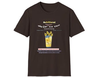 May include: A dark brown short-sleeve t-shirt featuring a graphic of a glass of yellow lemonade with ice and lemon slices. The text reads Nutritional Facts, You Car Do This, Amount Per Severing, Warning: may contain unstoppable determination.