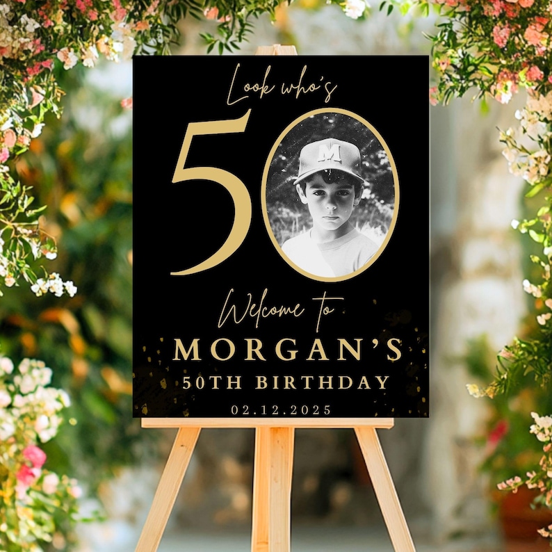 May include: Black and gold birthday sign with the number 50 and the text "Look who's 50. Welcome to Morgan's 50th Birthday 02.12.2025". A black and white photo of a young boy is in the center of the sign.