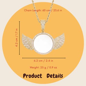 May include: A gold-toned pendant necklace featuring a circular center with wings on each side, encrusted with small clear stones. The chain length is 23.6 inches. The pendant measures 1.7 inches by 2.4 inches and weighs 0.9 ounces. Text reads Product Details.