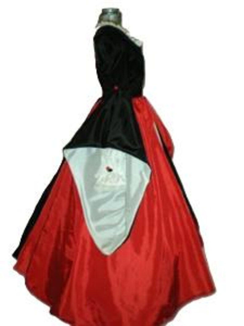 May include: A floor-length gown featuring a black bodice and a vibrant red skirt. The garment includes a black overskirt panel with a white lining that drapes over the front, accented by a small red detail at the waist and a white ruffled collar.