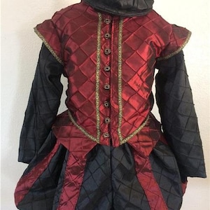 May include: A red and black quilted doublet and breeches costume with gold trim and buttons. The costume is on a mannequin and includes a black cap.