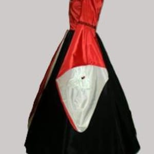 May include: A floor-length gown featuring a vibrant red bodice with long, wide sleeves that reveal a white lining. The skirt is constructed from a combination of black fabric panels and a prominent white triangular insert at the front center.