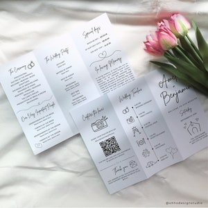 May include: A wedding invitation suite with a black and white design. The invitation features a timeline of the wedding day, including the ceremony, family photos, cocktail hour, reception dinner, open dance, and sing off. The invitation also includes a QR code for guests to share their photos from the wedding.