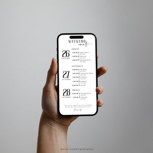 May include: A black and white mobile phone screen displaying a wedding weekend schedule with dates, times, and events. The text on the screen reads "Weekend Events" and lists events such as "Hotel Check-in", "Rehearsal", "Ceremony", and "Reception".