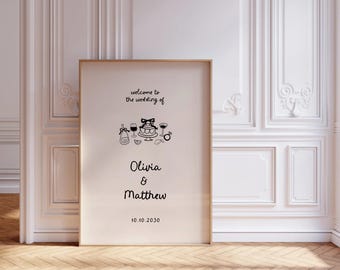 May include: A white wedding welcome sign with black text and illustrations. The text reads "Welcome to the wedding of Olivia & Matthew 10.10.2030". The illustrations include a bottle of champagne, two wine glasses, a wedding cake, and two rings.