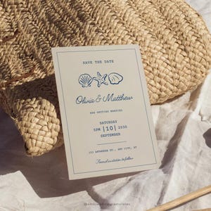 May include: Save the date card with a nautical theme. The card features a blue and white illustration of seashells and a starfish. The text reads "Save the Date, Olivia & Matthew are getting married, Saturday, 5PM | 10 | 2030, September, 123 Anywhere St., Any City, ST, Formal invitation to follow."