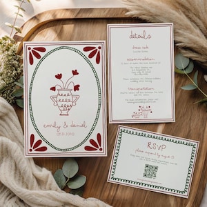 Peut inclure: Ensemble de faire-part de mariage avec un motif de vase floral rouge et vert. L'invitation comprend des détails, RSVP et des informations sur l'événement. L'ensemble est sur un plateau en bois avec des éléments décoratifs.