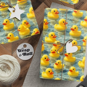 May include: Gift wrap featuring a pattern of yellow rubber ducks floating on water. The wrapped gifts are tied with twine and adorned with star and heart-shaped tags. A spool of twine, scissors, and tags are also present.