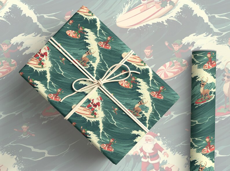 May include: A rectangular gift box wrapped in dark teal paper featuring a repeating pattern of Santa Claus, reindeer, and elves surfing on peppermint-striped surfboards amidst white ocean waves, tied with a thin white string in a bow.