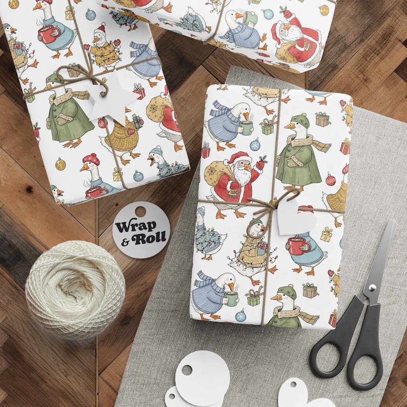 A gift wrapped in cute Christmas goose wrapping paper, featuring a whimsical pattern of geese dressed in sweaters, Santa hats, and tangled in lights on a white background. The present is tied with twine and surrounded by pine branches, creating a funny and festive look.