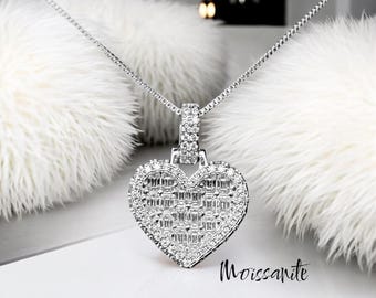 May include: A silver heart-shaped pendant necklace with a chain. The pendant is covered in small, clear cubic zirconia stones.