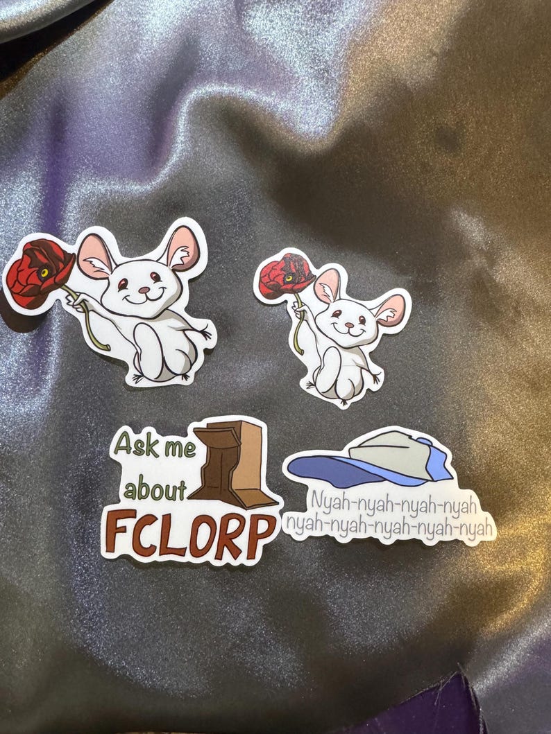 May include: Four stickers featuring a cartoon mouse holding a red poppy flower, a brown box with the text "Ask me about FCLORP", and a blue baseball cap with the text "Nyah-nyah-nyah-nyah nyah-nyah-nyah-nyah-nyah".