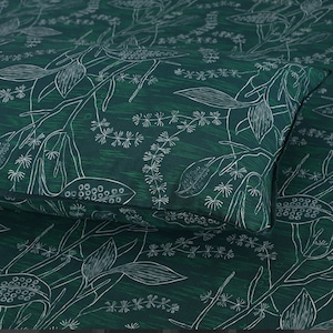 May include: A dark green fabric with a white floral pattern. The pattern features stylised leaves and seed pods.