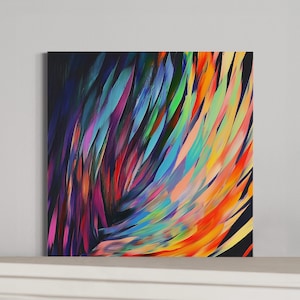 May include: Square canvas art featuring an abstract design of colorful brushstrokes. The artwork showcases a vibrant array of colors, including blues, greens, oranges, and purples, creating a dynamic and energetic composition. The background is a deep black.