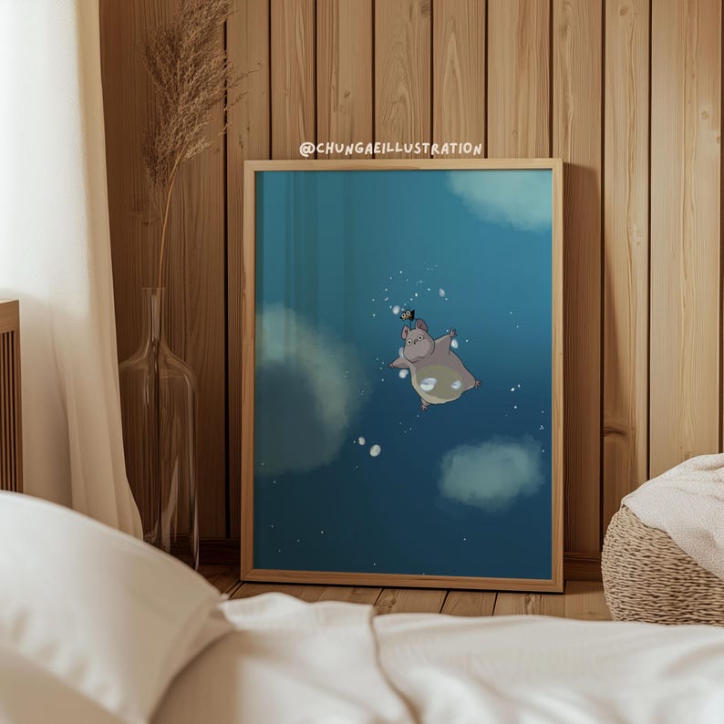 May include: A framed illustration of a cartoon hippo floating in a blue space with white clouds and bubbles. The hippo wears a small hat. The text "@CHUNGAEILLUSTRATION" is in the top right corner. The artwork is in a wooden frame.