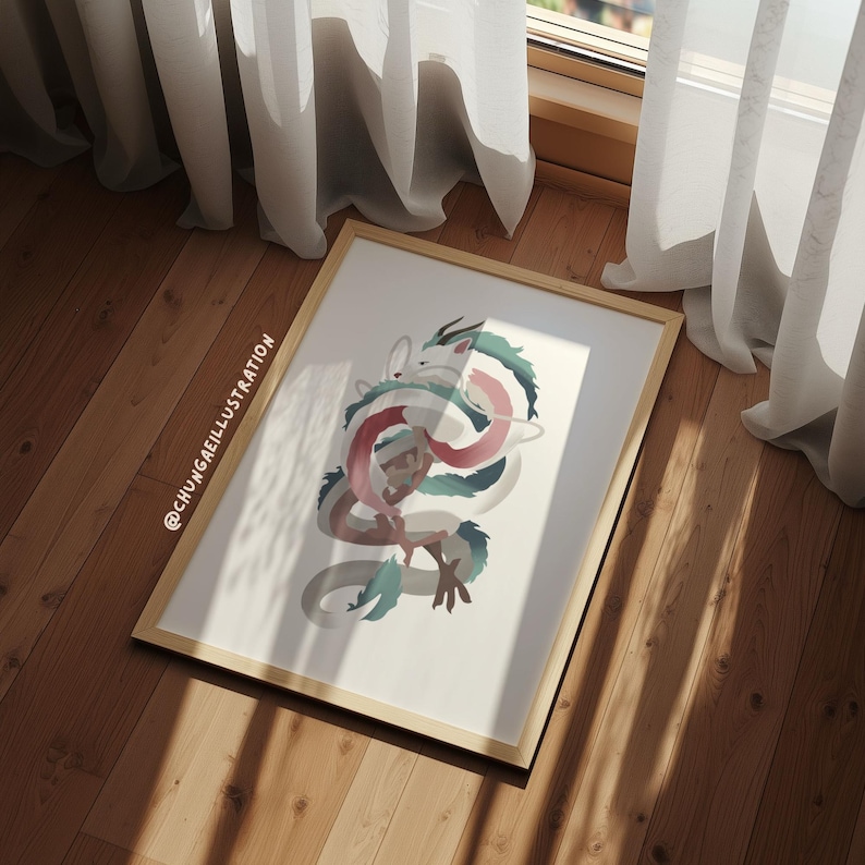 May include: A framed art print featuring a stylized illustration of a dragon with intertwined body. The dragon's body is a mix of white, pink, and teal colors. The frame is a light wood color, and the artwork is displayed on a wooden floor.