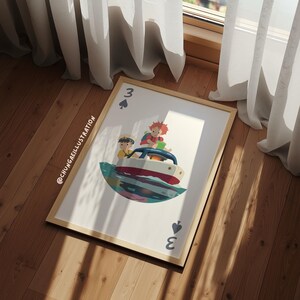 May include: A framed art print featuring a playing card design with a boat illustration. The card is a three of spades, with the number and suit symbol at the top and bottom. The boat has two figures and is set against a colorful background.