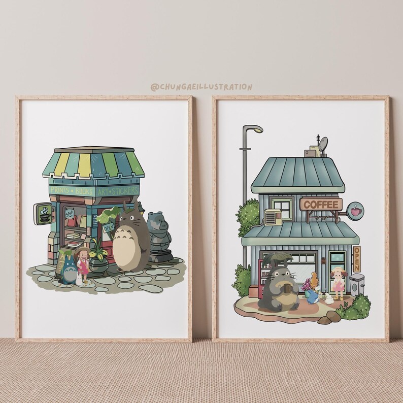 May include: Two framed art prints featuring whimsical illustrations. One depicts a shop with a green and yellow striped awning, and the other shows a coffee shop. Both prints feature cartoon characters and the text "@CHUNGAEILLUSTRATION".