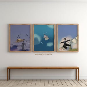 May include: Three framed art prints with whimsical illustrations. One features a turtle on power lines, another a hippo in the sky, and the third a figure in a black coat. The prints are displayed above a wooden bench.