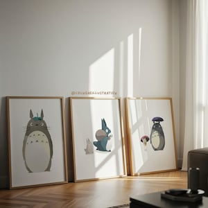 May include: Three framed art prints featuring characters from a popular animated film. The prints have a light wood frame and depict a large gray creature with a hat, a blue creature with a bag, and a large gray creature with an umbrella.