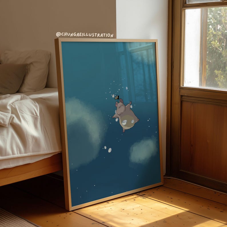 May include: A framed art print showing a cartoon hippo floating in a blue space with white clouds and bubbles. The hippo is light grey with a white belly. The artist's name, @CHUNGAEILLUSTRATION, is in the top left corner.