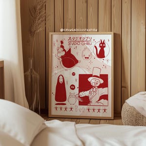 May include: A framed art print featuring red illustrations of characters from Studio Ghibli films. The print includes characters like Totoro, a cat, and a faceless spirit, set against a white background. The frame is a light brown color.
