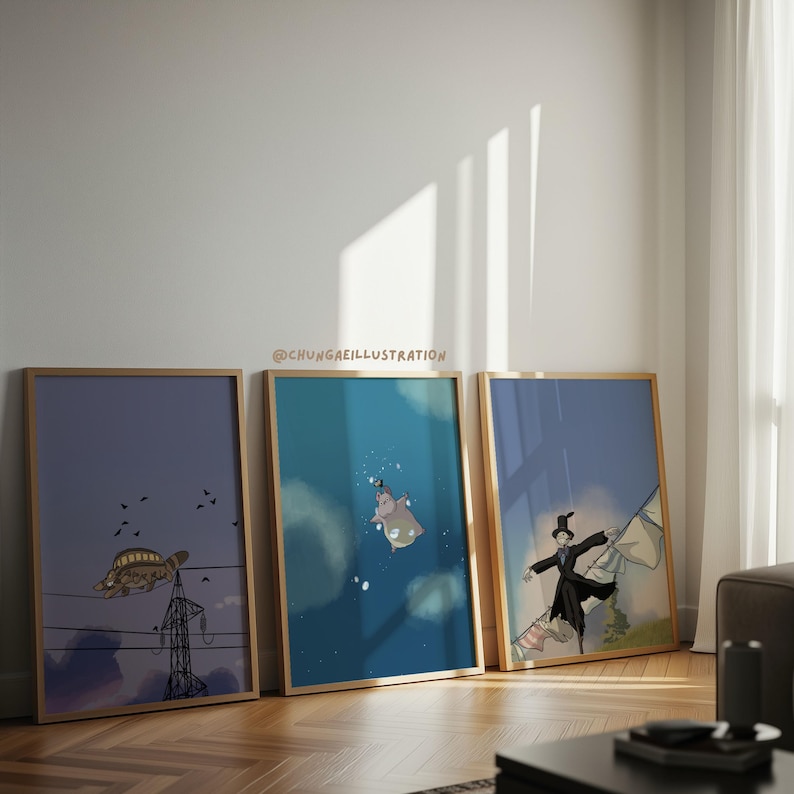 May include: Three framed art prints with whimsical illustrations. One features a turtle on power lines, another a hippo underwater, and the third a figure with a flag. The frames are light brown, and the artwork has a cartoonish style.