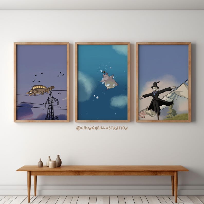 May include: Three framed art prints with wooden frames. The prints feature whimsical illustrations: a turtle-shaped airship, a hippo in the water, and a scarecrow figure. The background colors are blue and purple. The artist's name is visible in the image.