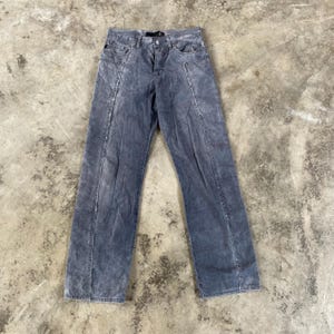 May include: A pair of dark gray corduroy pants with a straight leg fit. The pants have a faded look and have seams down the sides of the legs.