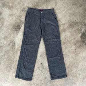 May include: A pair of gray wool blend pants with a straight leg fit. The pants have a button fly and belt loops.