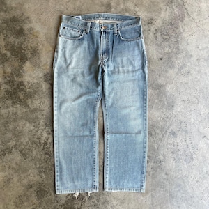 May include: Pale blue denim jeans with a traditional five-pocket design. The jeans have a straight leg cut and a faded wash, giving them a vintage appearance. The jeans are made of durable denim material and feature a button and zip closure.