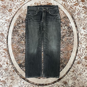 May include: Dark gray denim jeans with a classic five-pocket design. The jeans have a faded appearance and a straight leg cut. The image shows the jeans laid flat, showcasing the front and back details, including the button and zipper closure.