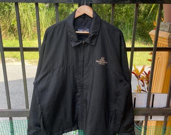 May include: Black jacket with a zipper closure and a gold embroidered logo that says "Honda President's Award".